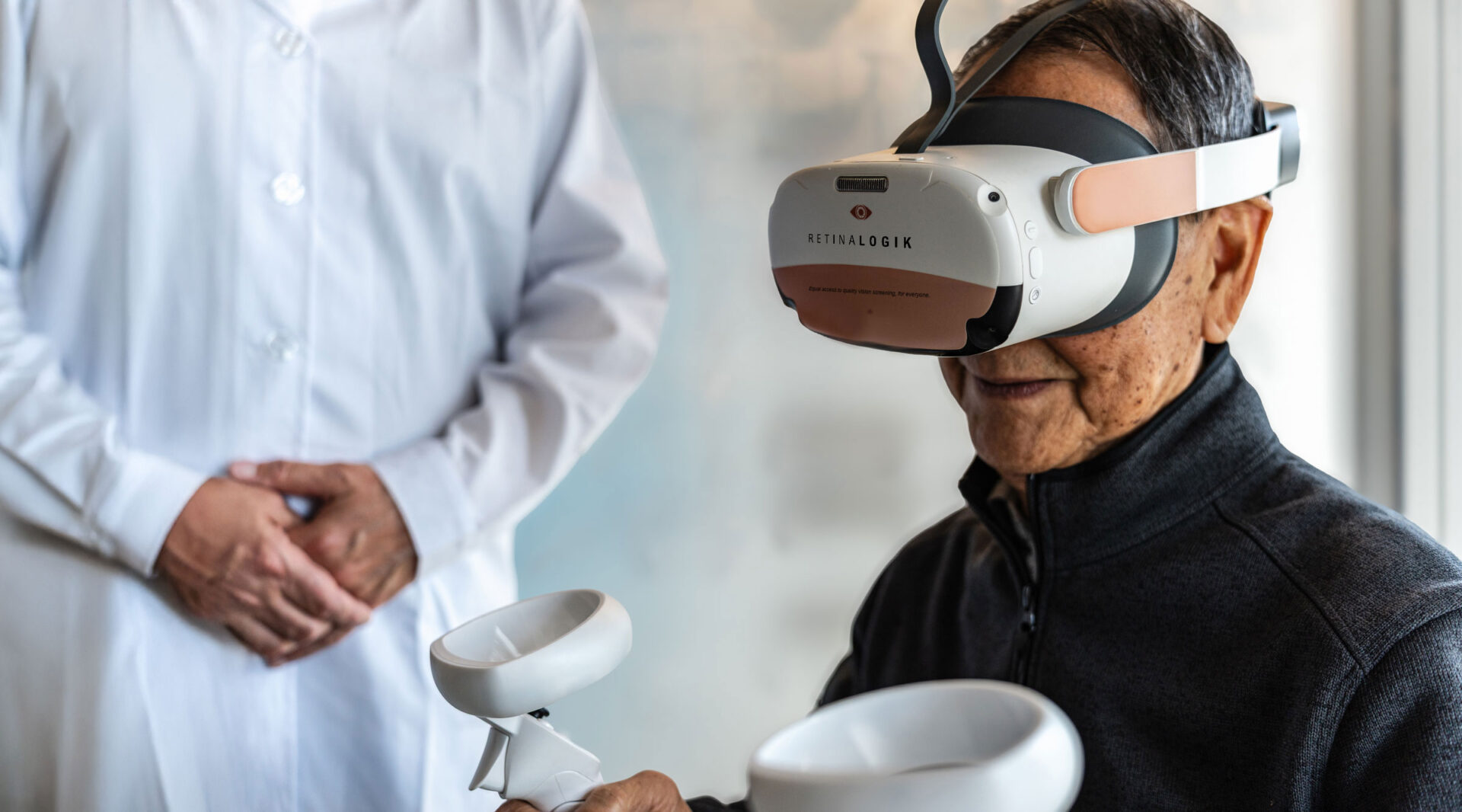 Senior patient completing virtual visual field testing with a RetinaLogik headset and controllers