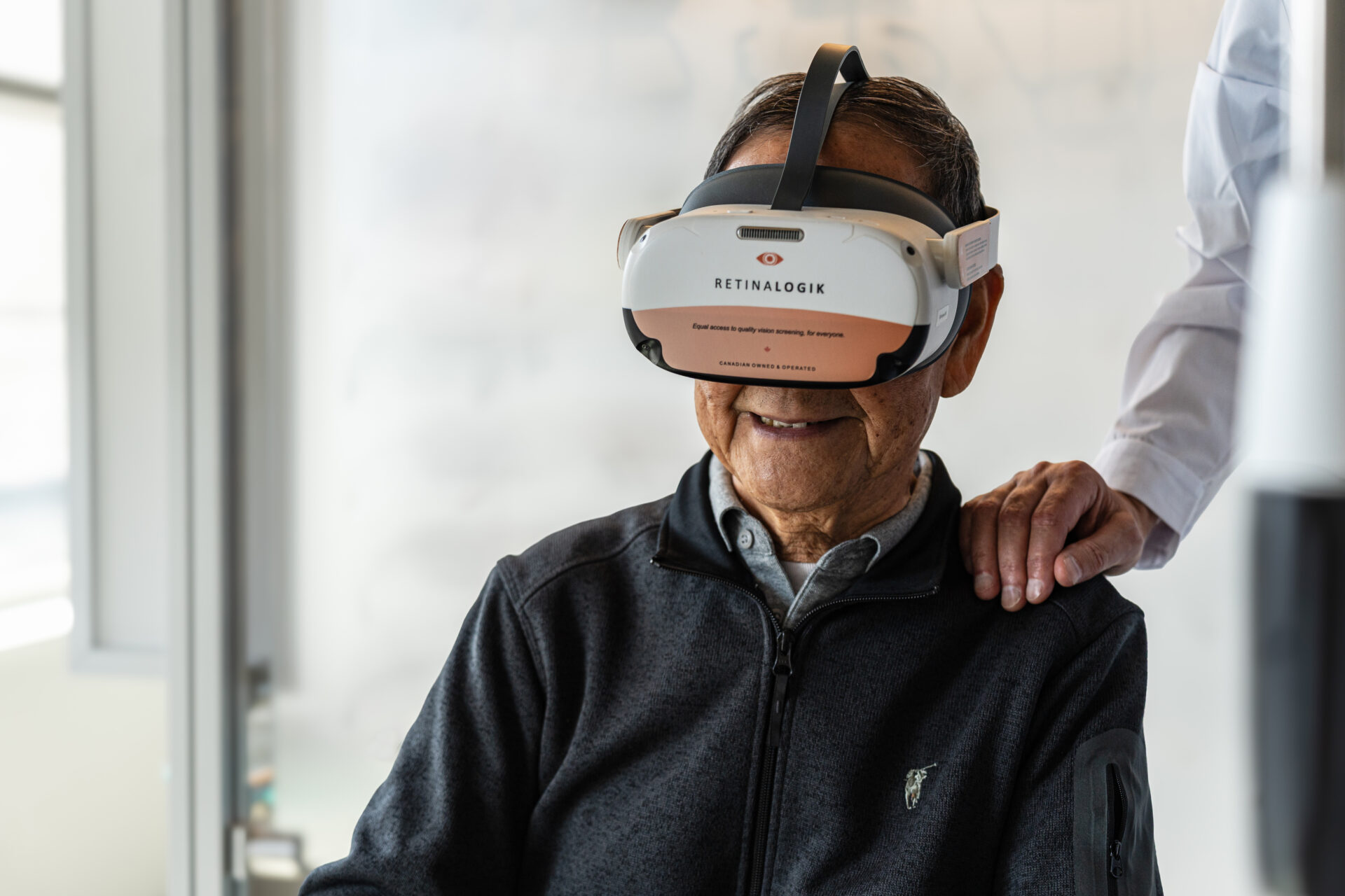 Senior patient wearing a RetinaLogik virtual visual field testing headset